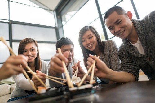 friends eating sushi - junk food stock pictures, royalty-free photos & images