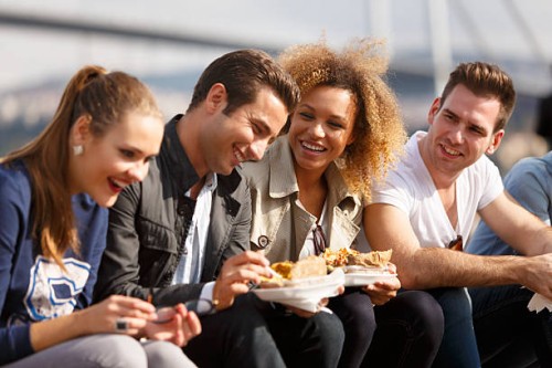 friends eating turkish baked potato near bosphorus bridge in ist - junk food stock pictures, royalty-free photos & images