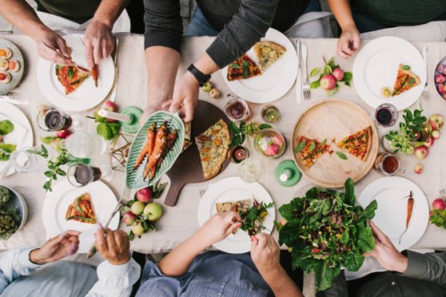 friends enjoying a dinner together in greenhouse harvest party - food stock pictures, royalty-free photos & images
