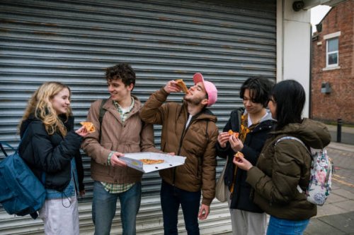 friends enjoying a pizza together - junk food stock pictures, royalty-free photos & images