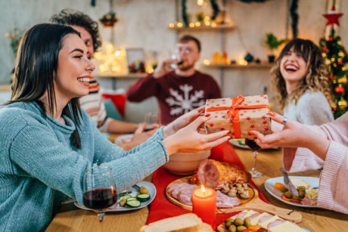 friends exchanging christmas presents - food stock pictures, royalty-free photos & images