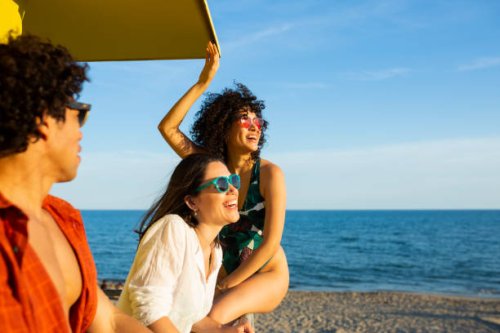 friends hanging out at the lifeguard station on the beach - travel stock pictures, royalty-free photos & images