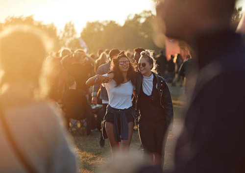 friends laughing together at big festival - concert stock pictures, royalty-free photos & images