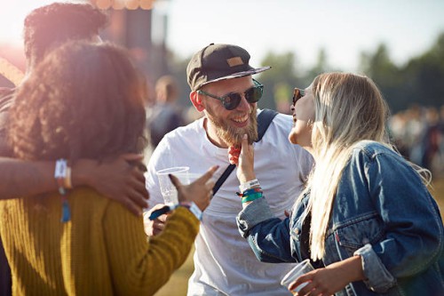 friends laughing together at concert - concert stock pictures, royalty-free photos & images