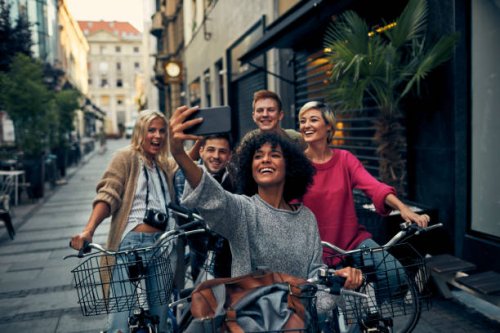 friends riding bicycles in a city - travel stock pictures, royalty-free photos & images