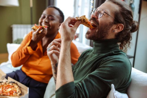 friends sharing pizza at home - junk food stock pictures, royalty-free photos & images