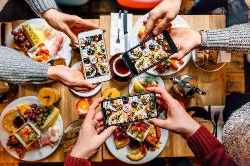 friends taking pictures of food on the table with smartphones during brunch in restaurant - food stock pictures, royalty-free photos & images