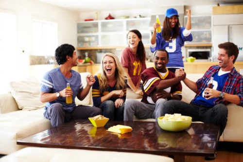 friends watching football in living room - food stock pictures, royalty-free photos & images
