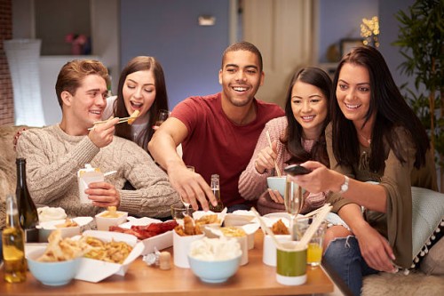 friends watching tv with take away - junk food stock pictures, royalty-free photos & images