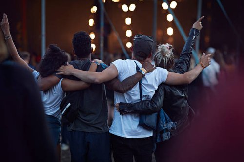 friends with arms around each other at concert - concert stock pictures, royalty-free photos & images