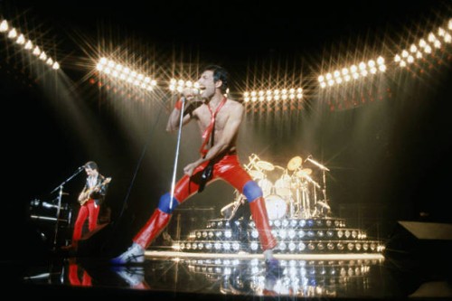 From left to right, musicians John Deacon and Freddie Mercury of the British rock band Queen perform in concert at the Forum on July 9, 1980 in...