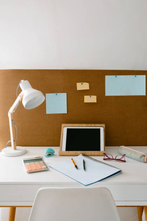 front view image of a study area in a girl's or teenager's room with a desk with study material for homework, and a cork board with map. - home decoration stock pictures, royalty-free photos & images