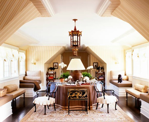 front view of a big lamp placed on a round table with books, plants and statuettes arranged around it - home decoration stock pictures, royalty-free photos & images