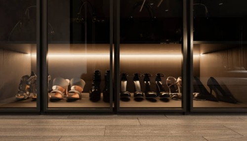 front view of a group of women's heels on a shelf with glass doors in a room in the foreground. - fashion stock pictures, royalty-free photos & images