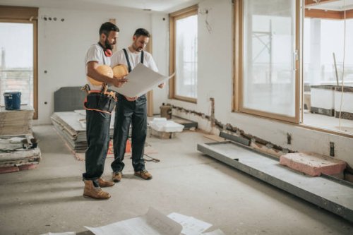full length of construction workers analyzing blueprints in the apartment. - home decoration stock pictures, royalty-free photos & images