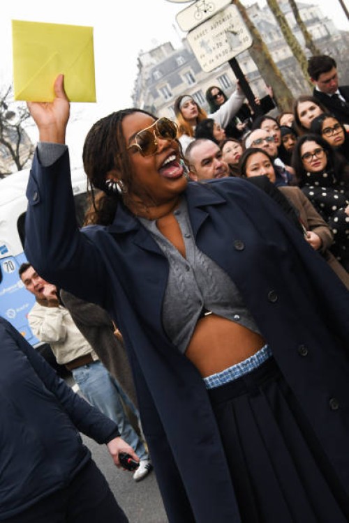 Gabriella Karefa-Johnson is seen wearing a blue coat, gray Miu Miu top, blue skirt outside Miu Miu show during the Womenswear Fall/Winter 2025/2026...