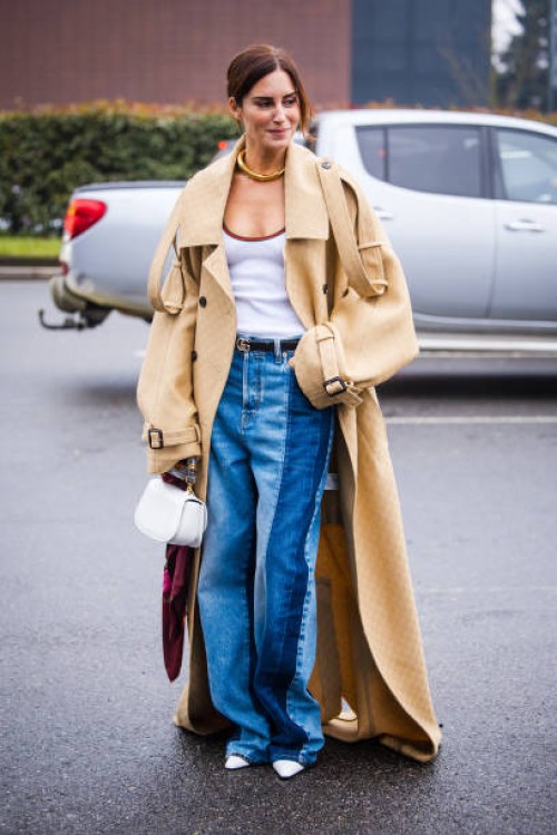 Gala Gonzalez is seen wearing beige long trench coat, white shirt, two tone denim jeans a white bag outside Gucci during the Milan Fashion Week...