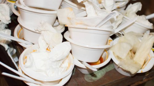 garbage can overstuffed bin with plastic plates and forks - junk food stock pictures, royalty-free photos & images