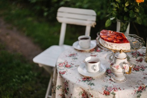 garden table with teacups, teapot and strawberry cake on - garden decoration stock pictures, royalty-free photos & images