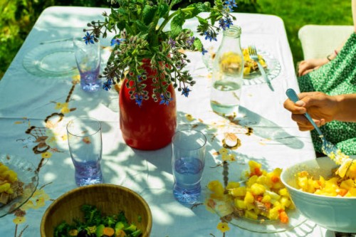 garden table with white tablecloth and food on a spring day - garden decoration stock pictures, royalty-free photos & images