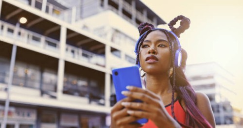 gen z woman, music phone and city street fashion, trendy style and cool attitude influencer. hipster black girl listening to audio with headphones, social media apps and unique urban youth lifestyle - fashion stock pictures, 