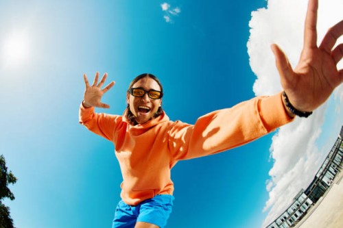 generation z teenage boy looking down at the camera, shot wide angle. - fashion stock pictures, royalty-free photos & images