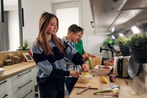 generation z teenagers making salad in kitchen - food stock pictures, royalty-free photos & images