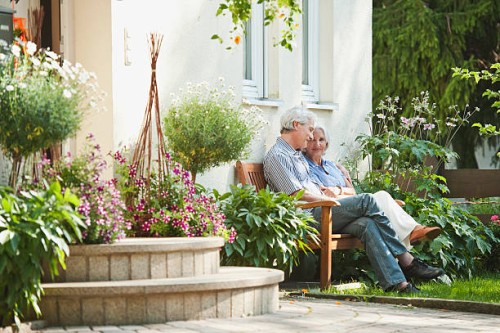 germany, bavaria, man and woman sitting in garden - garden decoration photos et images de collection