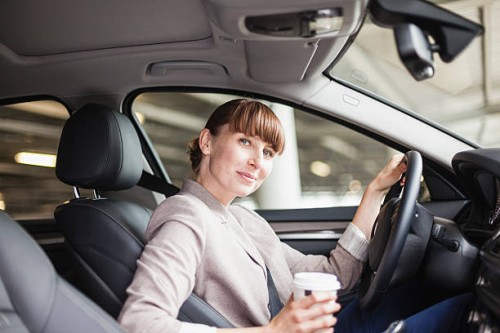 germany, hesse, frankfurt, portrait of smiling businesswoman with coffee to go sitting in her car - junk food stock pictures, royalty-free photos & images