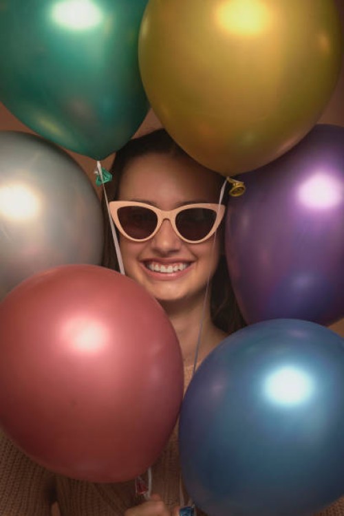 gift, girl and happy with sunglasses for balloons, celebration event and cool for birthday occasion. party, female teenager and portrait with accessory for fashion, excited and inflatable for decor - home decoration stock pic