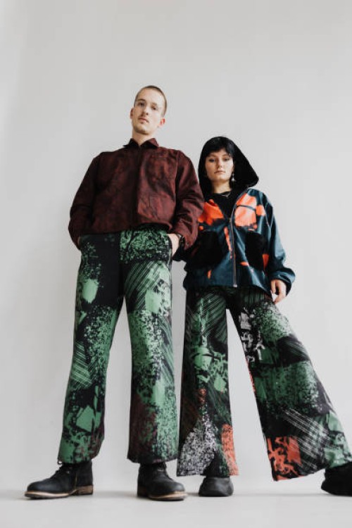 girl and boy stand close to each other wearing baggy clothing and looking into the camera - fashion stock pictures, royalty-free photos & images