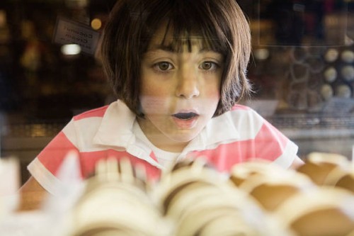 girl awed by chocolate bonbons in glass case - food stock pictures, royalty-free photos & images
