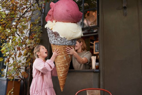 girl buying large ice cream from take out counter of cafe - junk food stock pictures, royalty-free photos & images