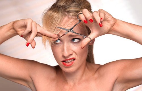 girl cutting own hair - hairstyle stock pictures, royalty-free photos & images