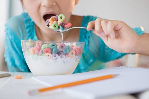 girl eating bowl of cereal - junk food stock pictures, royalty-free photos & images