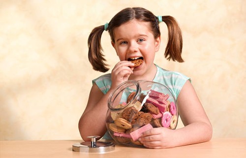 girl enjoying jar of cookies - junk food stock pictures, royalty-free photos & images