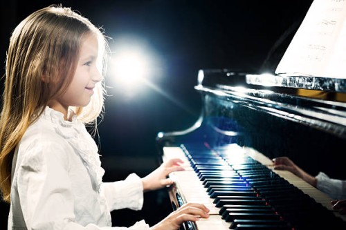 girl playing the piano. - concert stock pictures, royalty-free photos & images