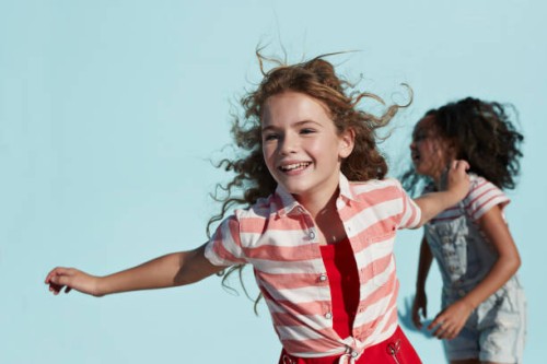 girl running with arms out, on studio background - fashion stock pictures, royalty-free photos & images