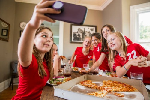 girl taking selfie with friends while eating pizza - junk food stock pictures, royalty-free photos & images