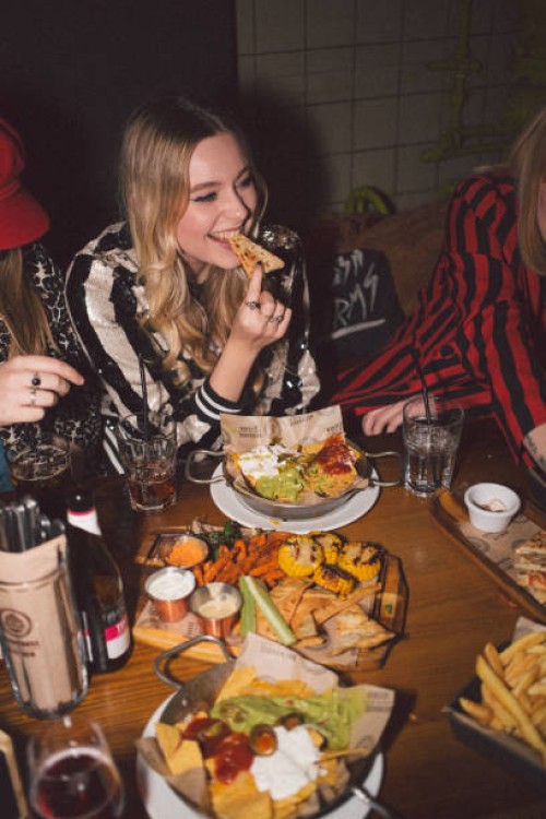 girlfriends on a night out - food fotografías e imágenes de stock