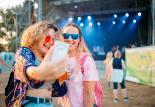 girlfriends taking selfie on daytime outdoor music festival - concert stock pictures, royalty-free photos & images