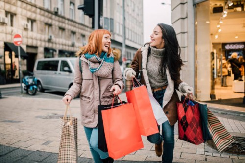 girls carrying shopping bags - fashion stock pictures, royalty-free photos & images
