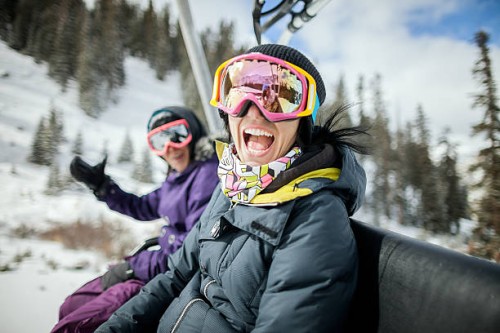girls laughing and having fun on a chair lift. - fashion stock pictures, royalty-free photos & images