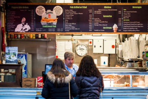 girls queuing at fish and chips counter, london, uk - junk food stock pictures, royalty-free photos & images