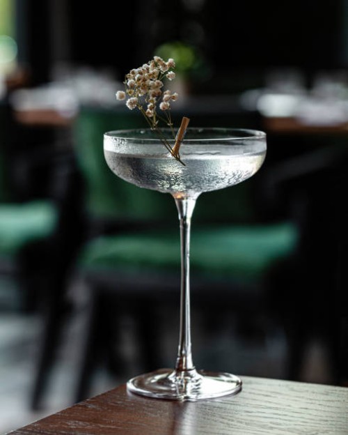 glass goblet of transparent cocktail garnished with flowers - food stock pictures, royalty-free photos & images