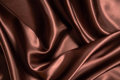glossy brown satin textured background with waves and folds. cloth material backdrop for luxury products presentation. flat lay, close up - fashion stock pictures, royalty-free photos & images
