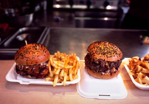 gourmet burgers and french fries against blurred background - junk food stock pictures, royalty-free photos & images