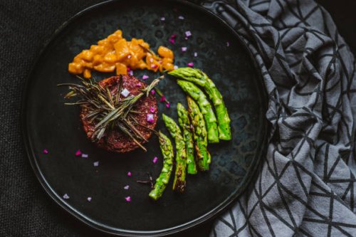gourmet vegan burger served with grilled asparagus and mango chutney - food stock pictures, royalty-free photos & images