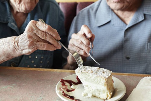 grandpa and grandma sharing cake - food stock pictures, royalty-free photos & images
