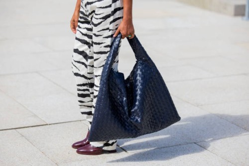 Grece Ghanem is seen wearing navy Bottega Veneta bag, zebra print pants outside OpéraSport during the Copenhagen Fashion Week SS25 on August 05, 2024...